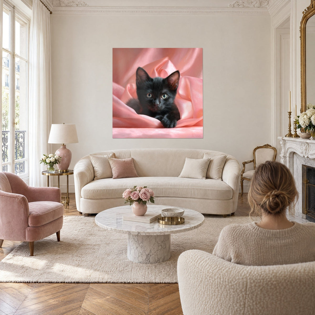 Wall art black kitten with silky coat and green eyes, curled up on pale pink satin, above a sofa in a bright living room