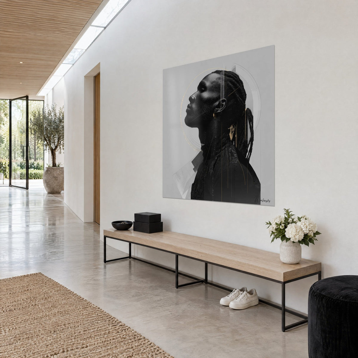 Wall art African face turned toward the sky, black silhouette and fine gold lines on light grey, white wall of a hallway