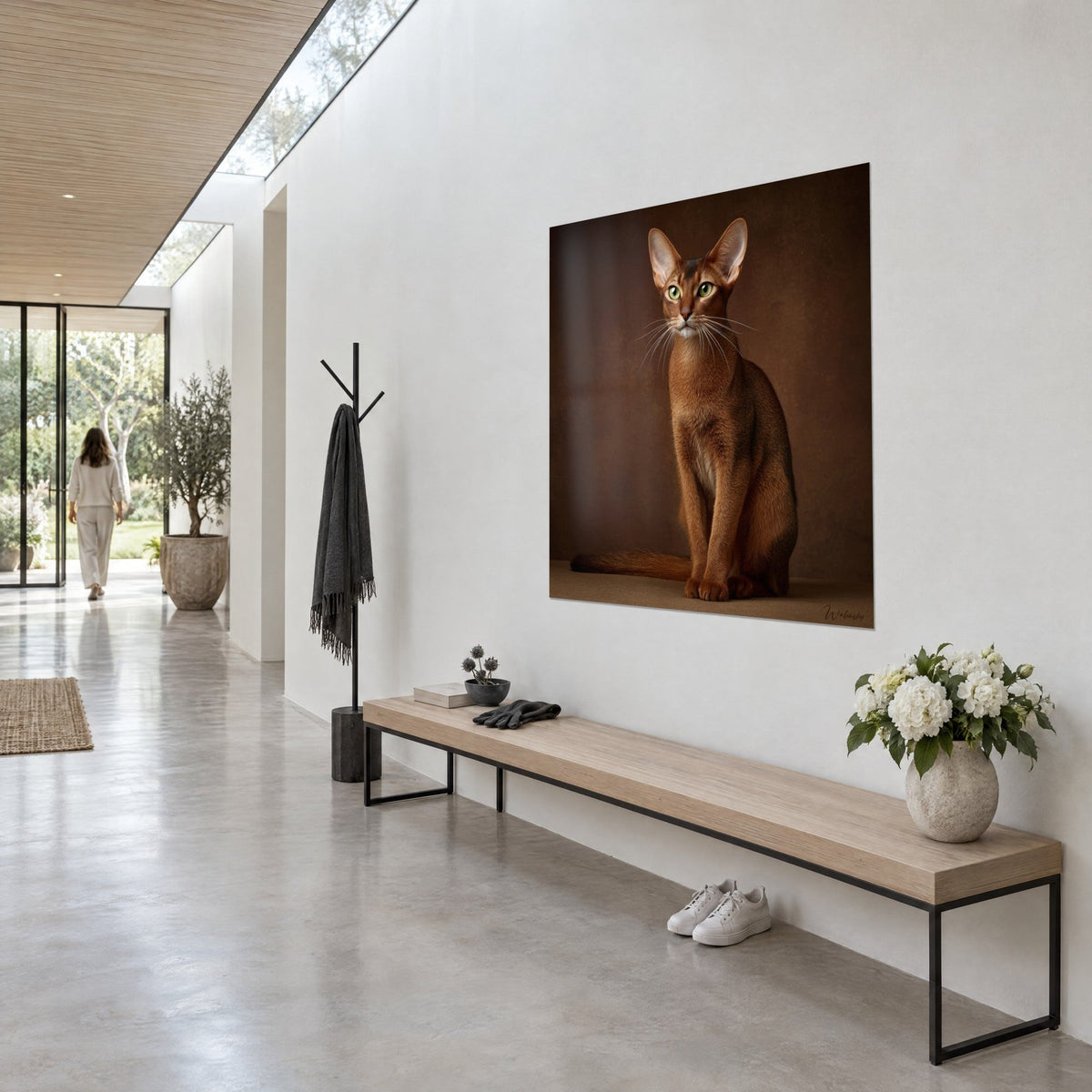 Wall art copper-coated feline with large ears, white whiskers on a chocolate background, white hallway wall in three-quarter view