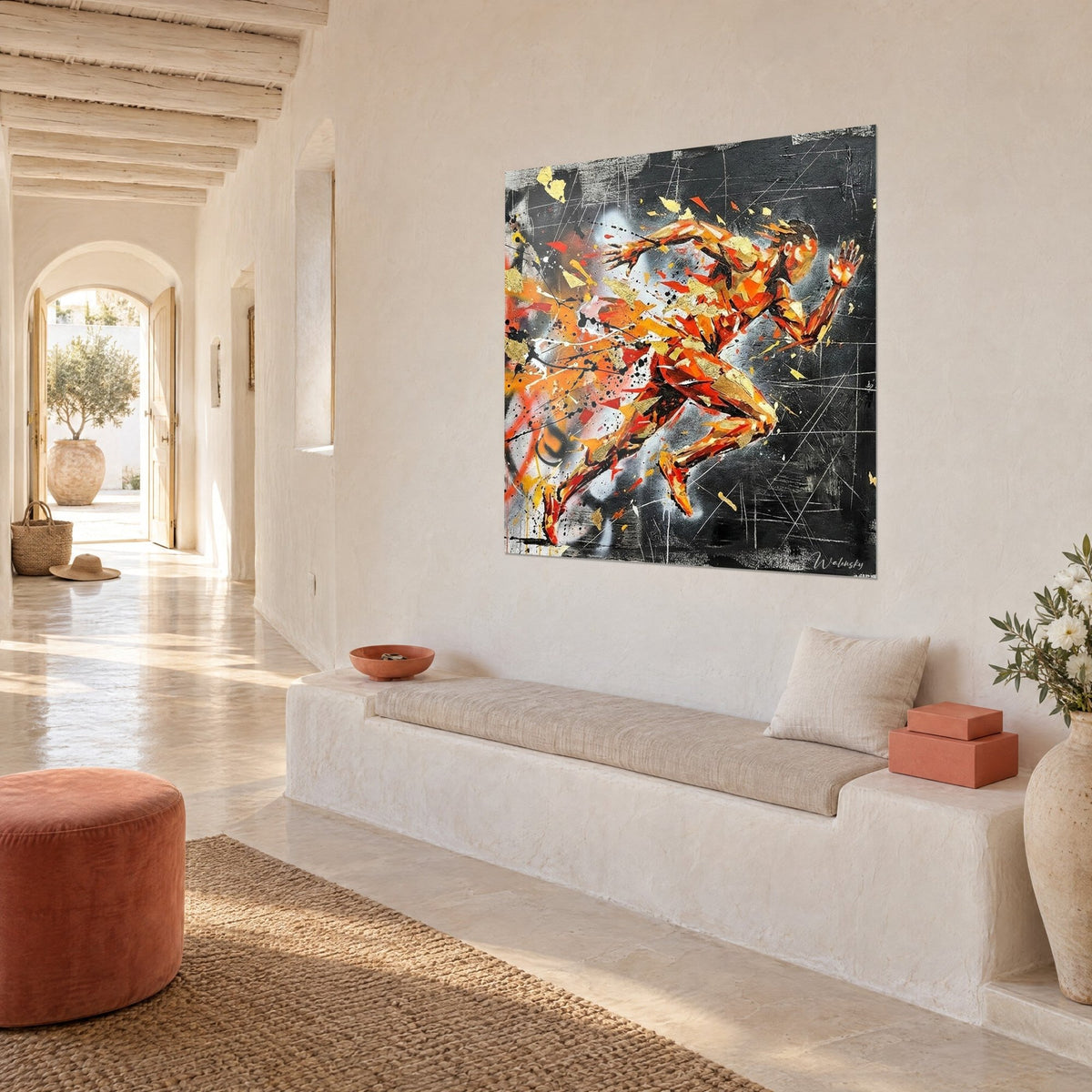 Wall art athlete mid-stride, gold leaf and white strokes etched on black, white wall of a Mediterranean home