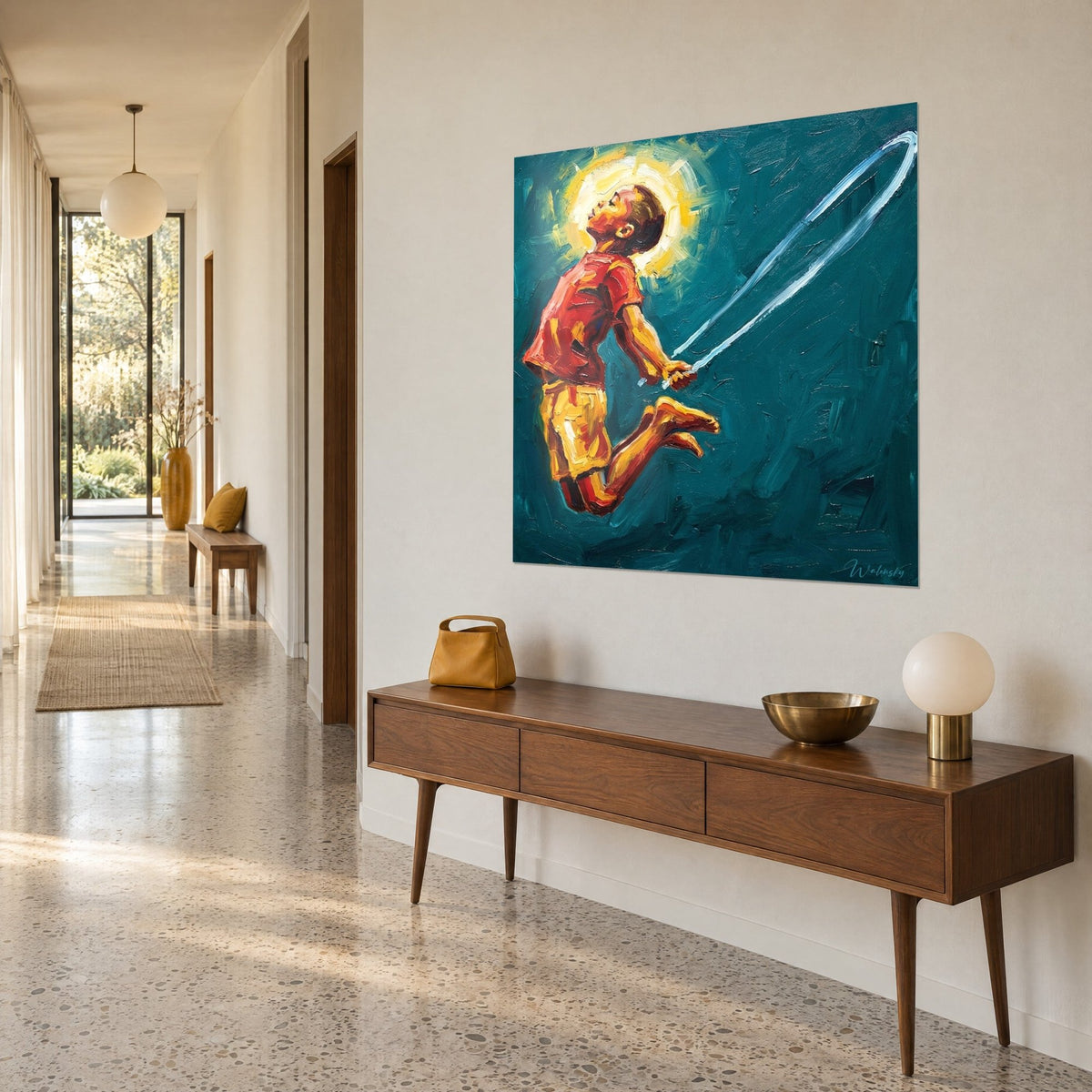 Wall art child jumping in a red t-shirt and yellow shorts, white rope arcing on turquoise background, angled view above a wooden console