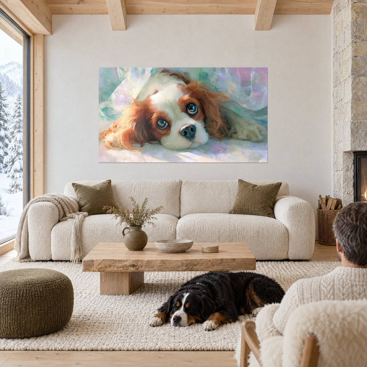 Wall art of a Cavalier King Charles puppy with blue eyes, white and red coat under a pastel veil, black dog lying down, above a sofa in a bright living room