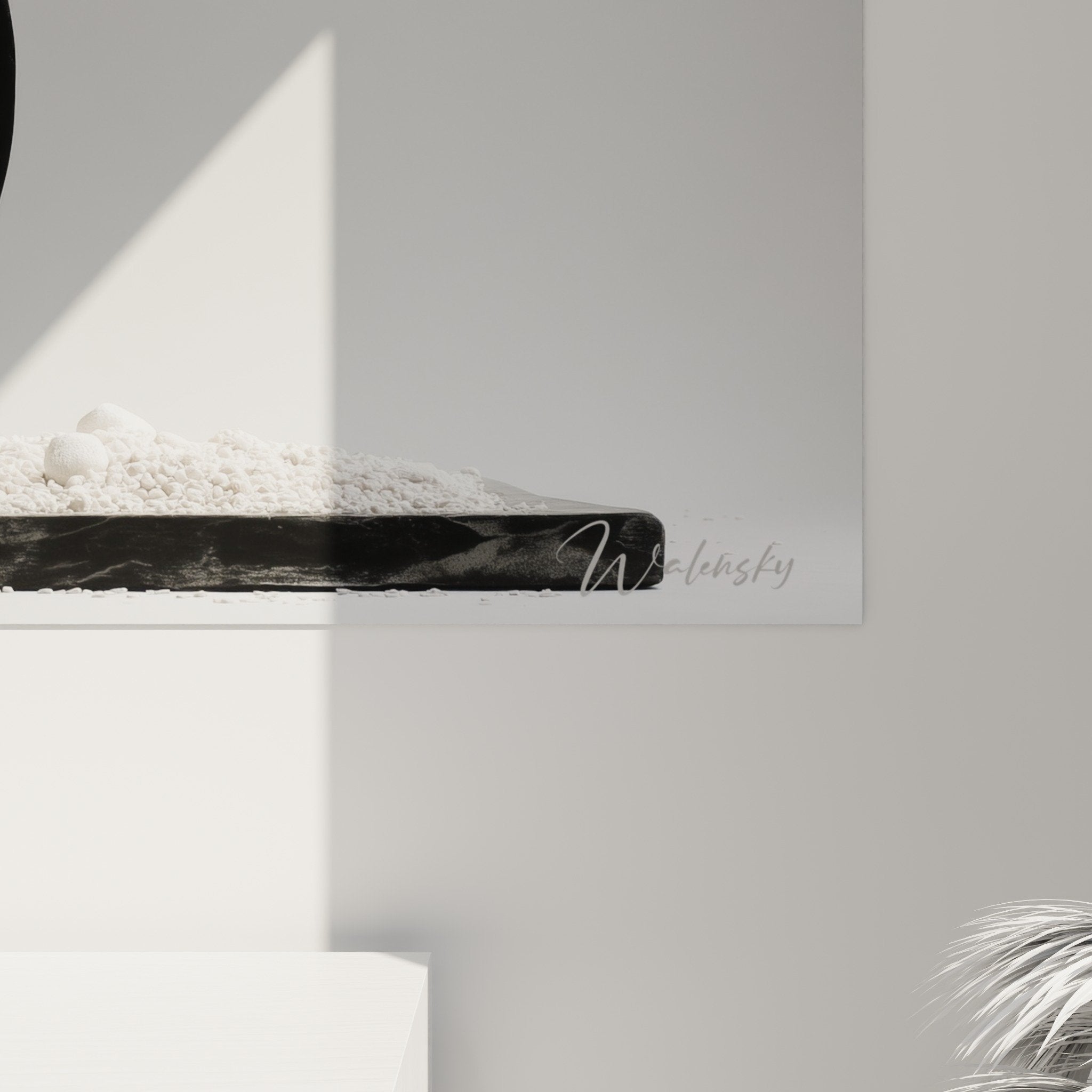 Overall view of ikebana composition with white pebbles tray black circle gray wall zen decoration