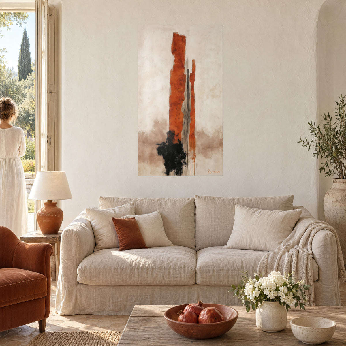 Wall art rust-orange monolith with frayed edges on cream background, black smudge at the bottom, couple seen from behind above a sofa in a bright living room