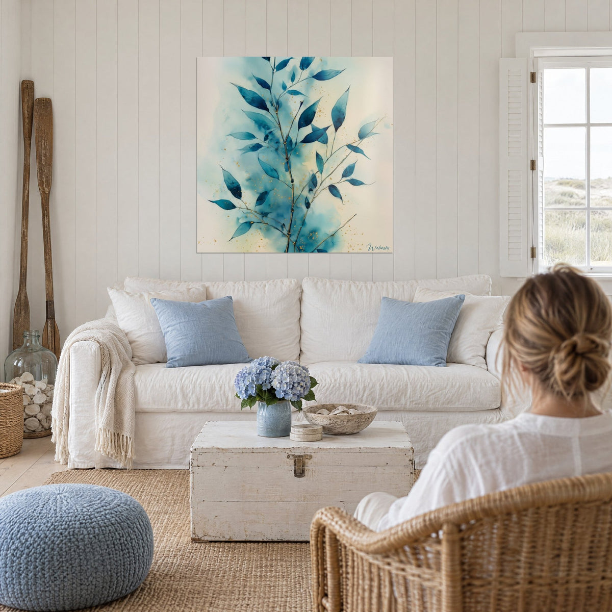 Wall art turquoise leaf sprig with gold accents, watercolor on cream background, above a sofa in a bright living room