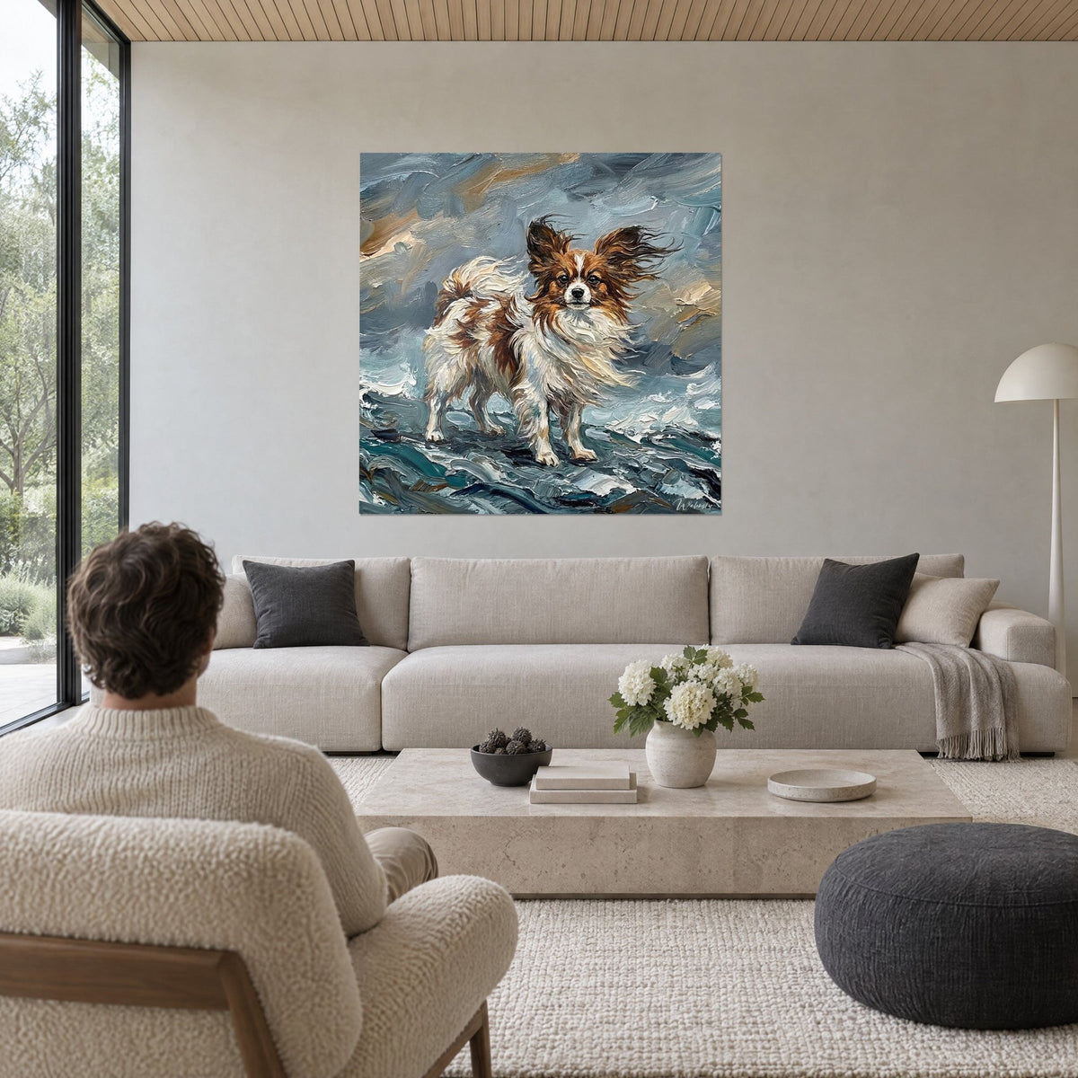 Wall art dwarf spaniel with upright ears, white and red coat tousled by the wind, above a sofa in a bright living room
