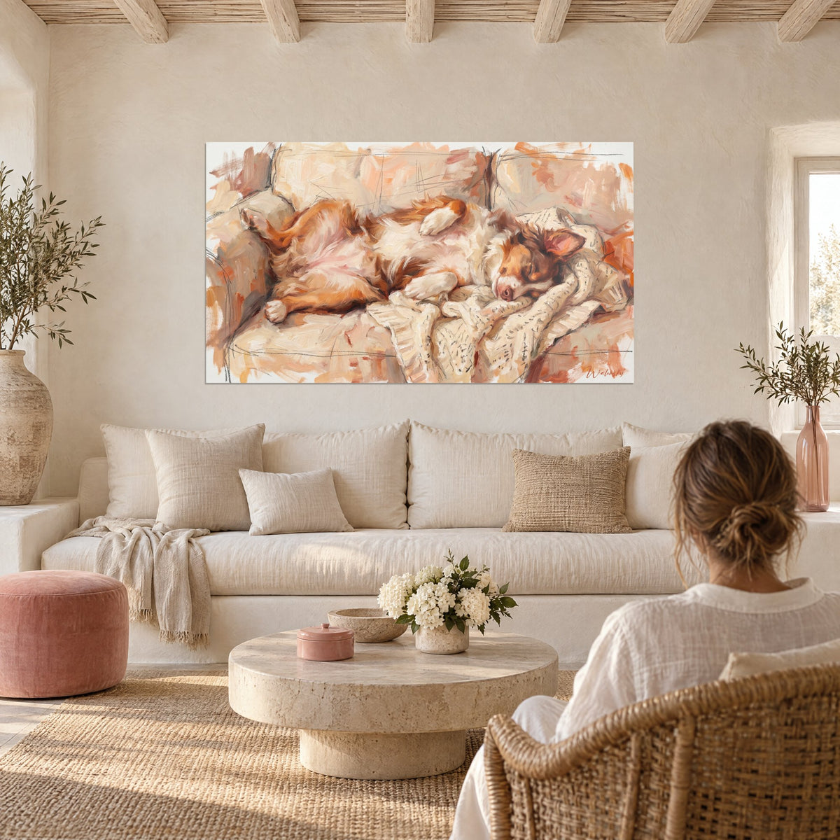 Wall art Red and white dog asleep on a beige sofa, cream knitted throw, two people seen from behind above a sofa in a bright living room