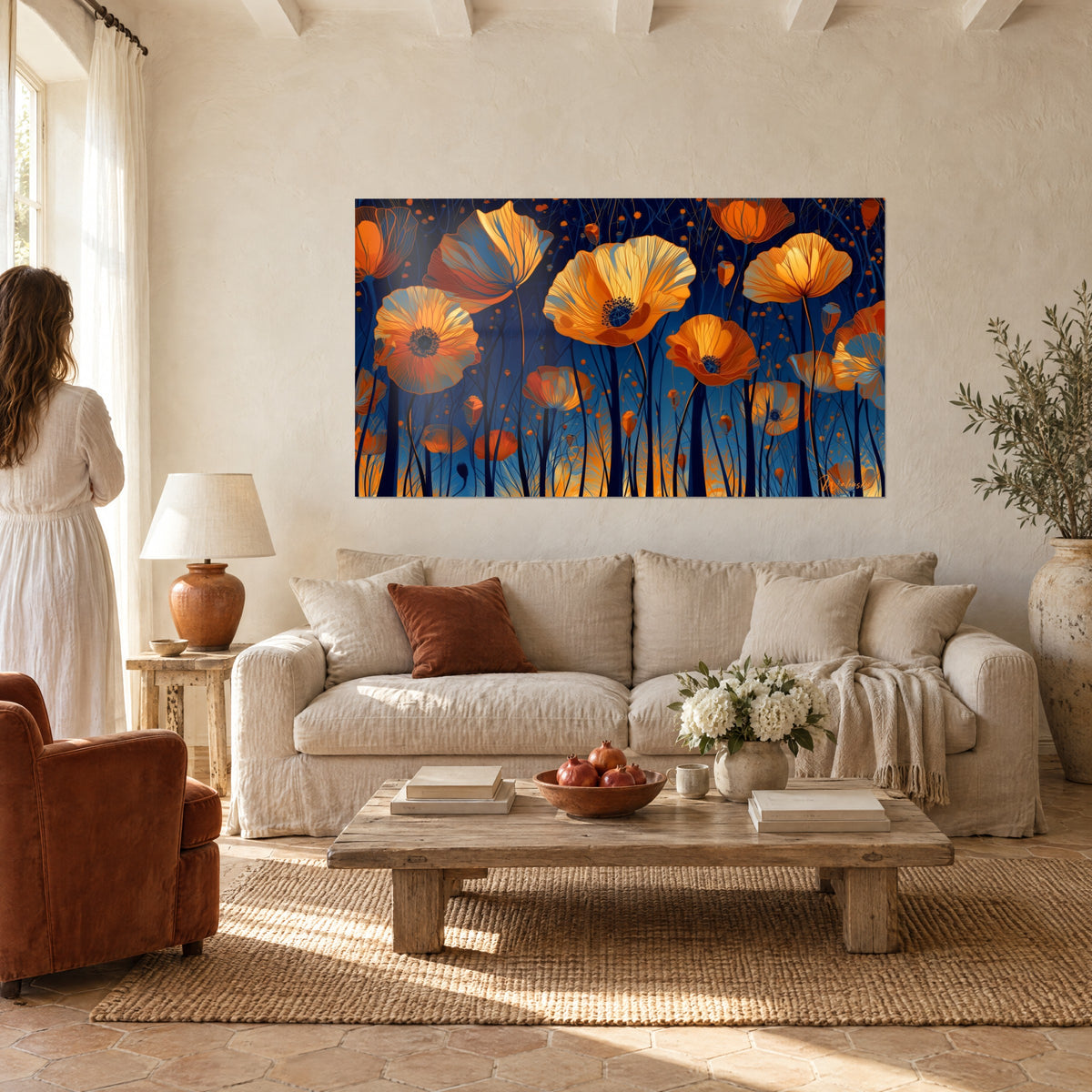 Wall art with orange poppies with veined petals on navy background, dark stems, couple seen from behind above a sofa in a bright living room