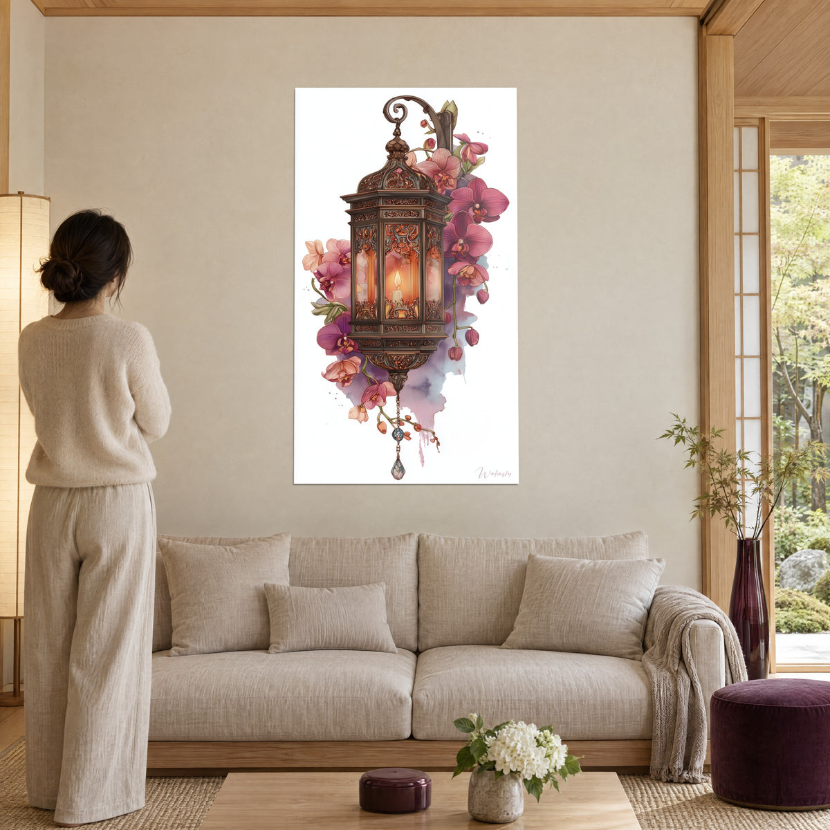 Wall art oriental lantern in openwork bronze, amber candle and pink orchids, above a sofa in a bright living room