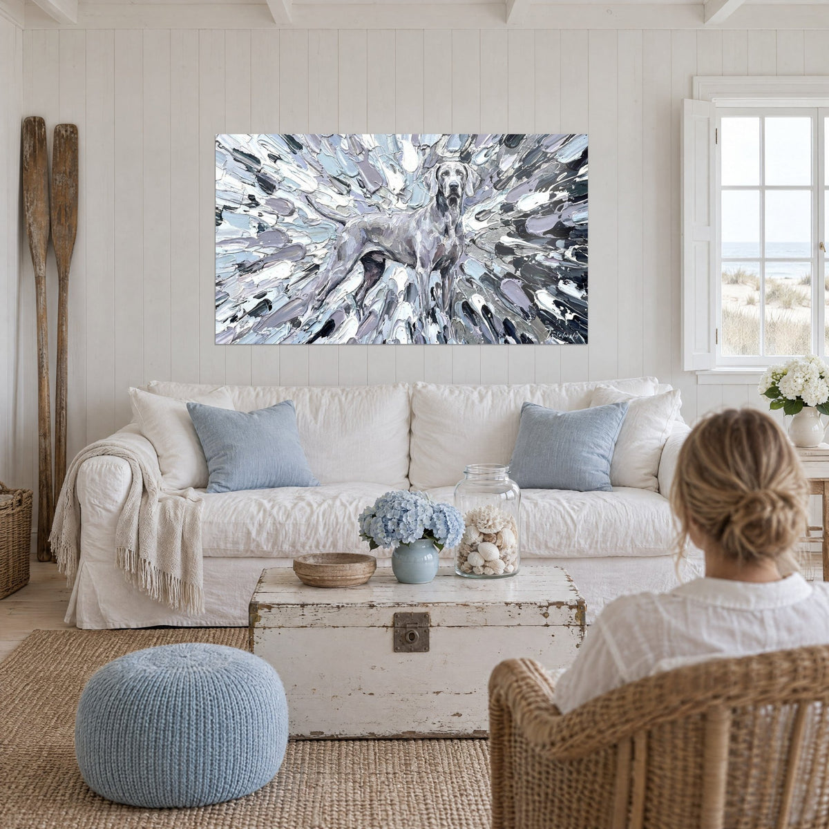 Silver-grey Weimaraner wall art on thick lavender and white paint bursts, seen from behind, hanging above a sofa in a bright living room