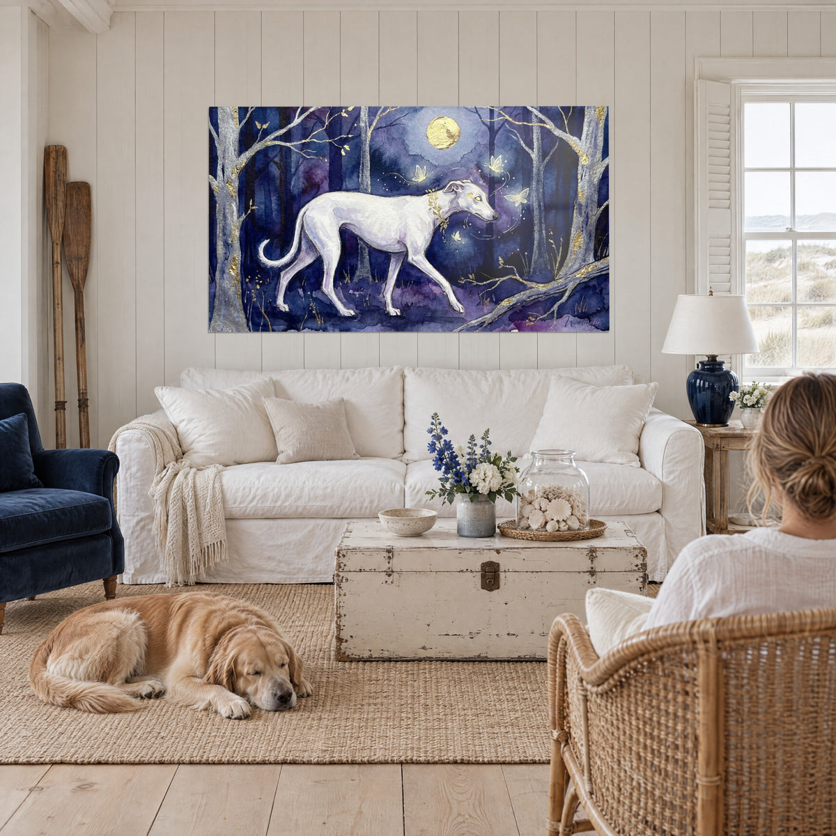 Cuadro de un galgo blanco, fino y elegante, en un bosque índigo, luna dorada, colgado encima del sofá en un salón luminoso