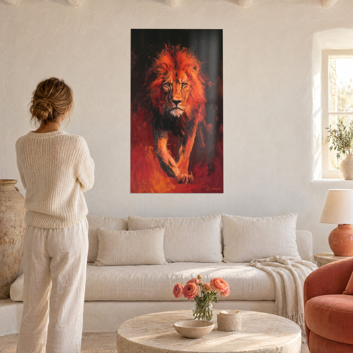 Gemälde Löwe mit leuchtend orangefarbener Mähne auf schwarzem Hintergrund, blutrotes Fell, Frau von hinten, über einem Sofa in einem hellen Wohnzimmer