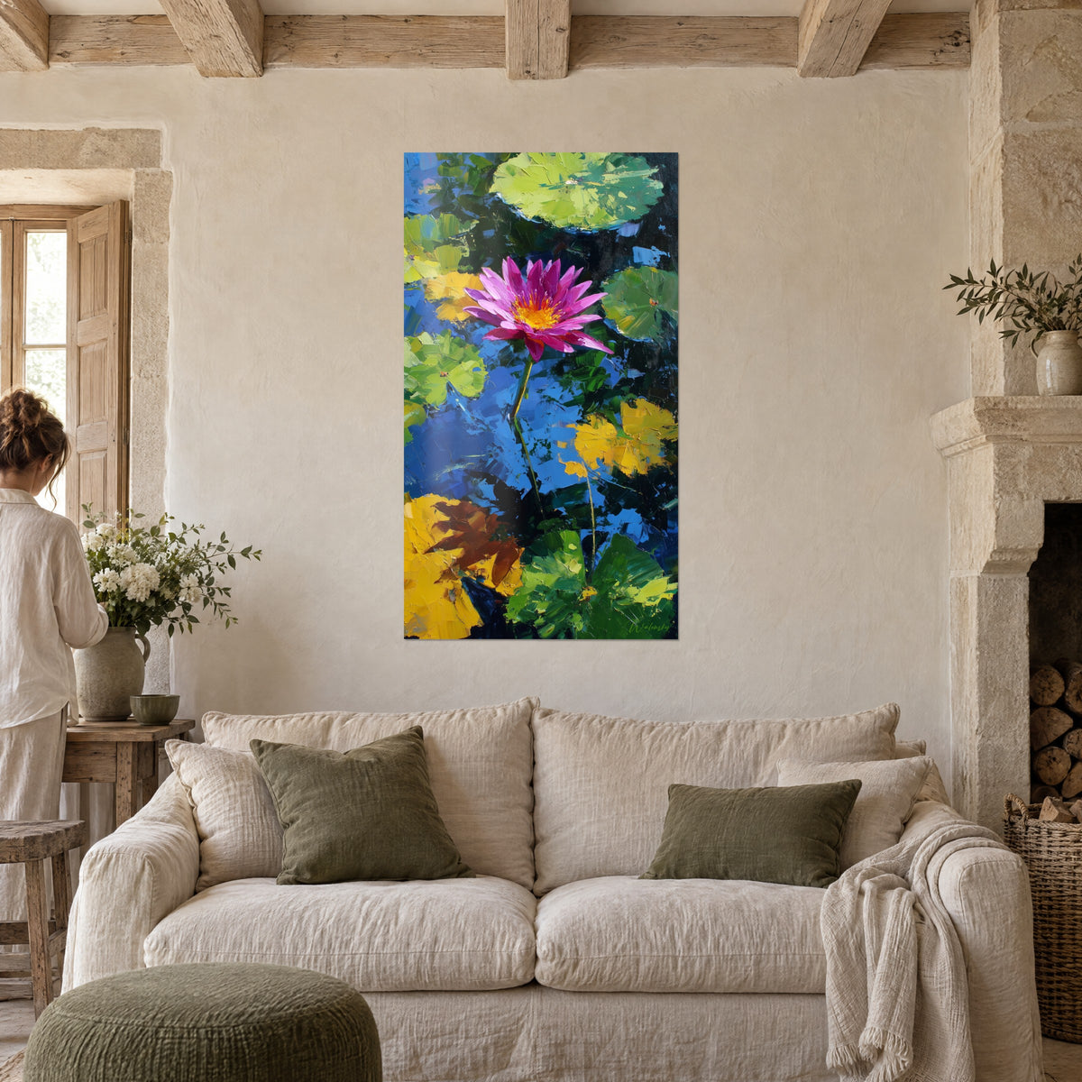 Wall art pink lotus flower with fuchsia petals and orange center on cobalt blue water, above a sofa in a bright living room