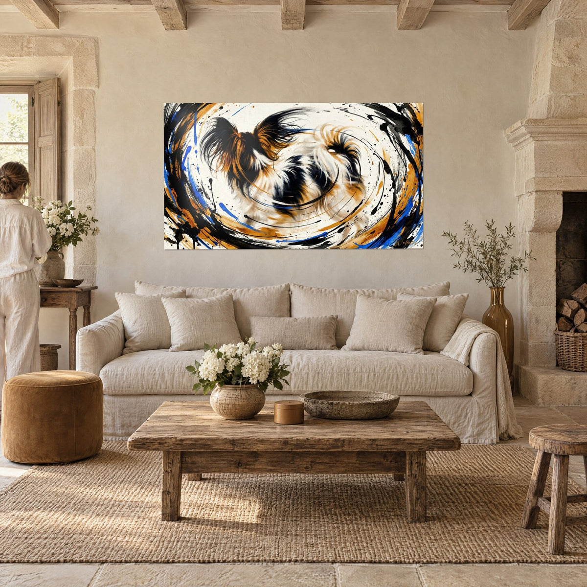 Wall art spinning butterfly dog, gold and black ears, cobalt blue splashes, above a sofa in a bright living room