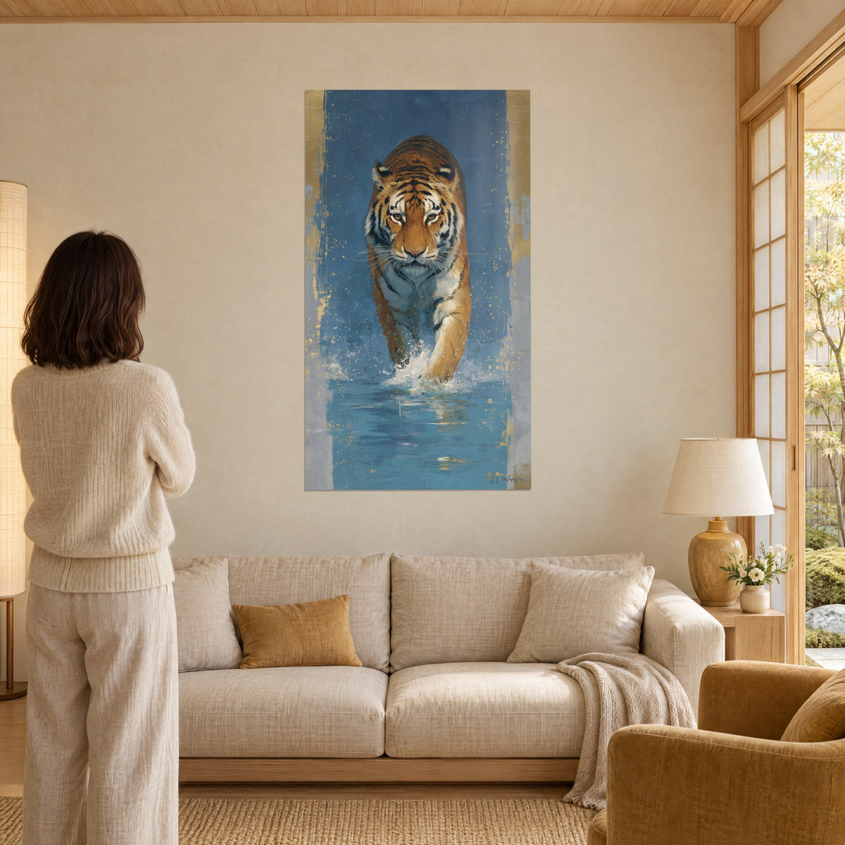 Wall art of a Bengal tiger striding through blue water, orange and white coat, golden splashes, above a sofa in a bright living room