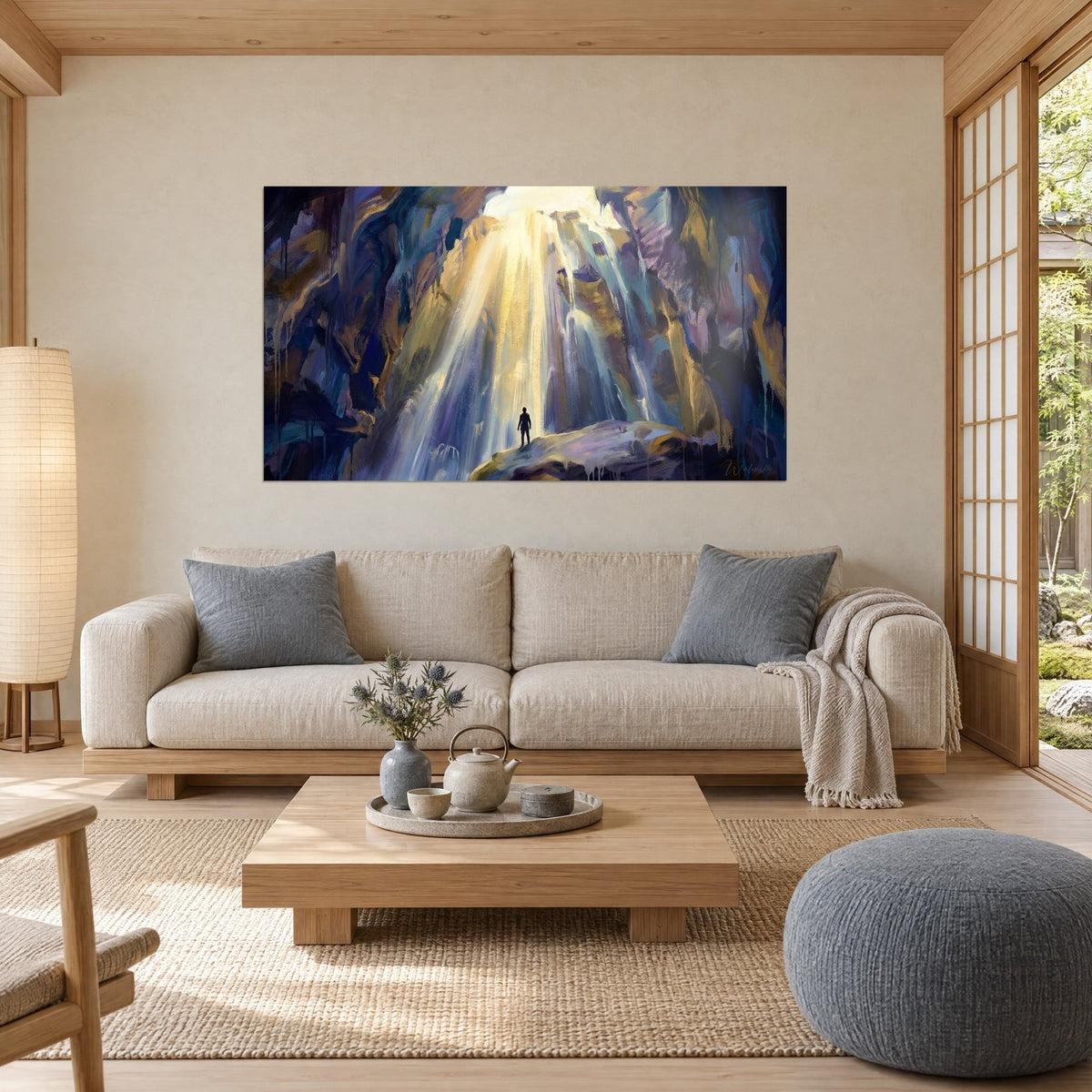 Wall art black silhouette facing a cascade of golden light, violet rocks and midnight blue, above a sofa in a bright living room