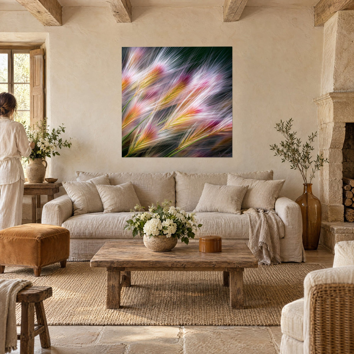 Wall art golden barley ears with white and pink awns, motion blur, couple seen from behind above a sofa in a bright living room