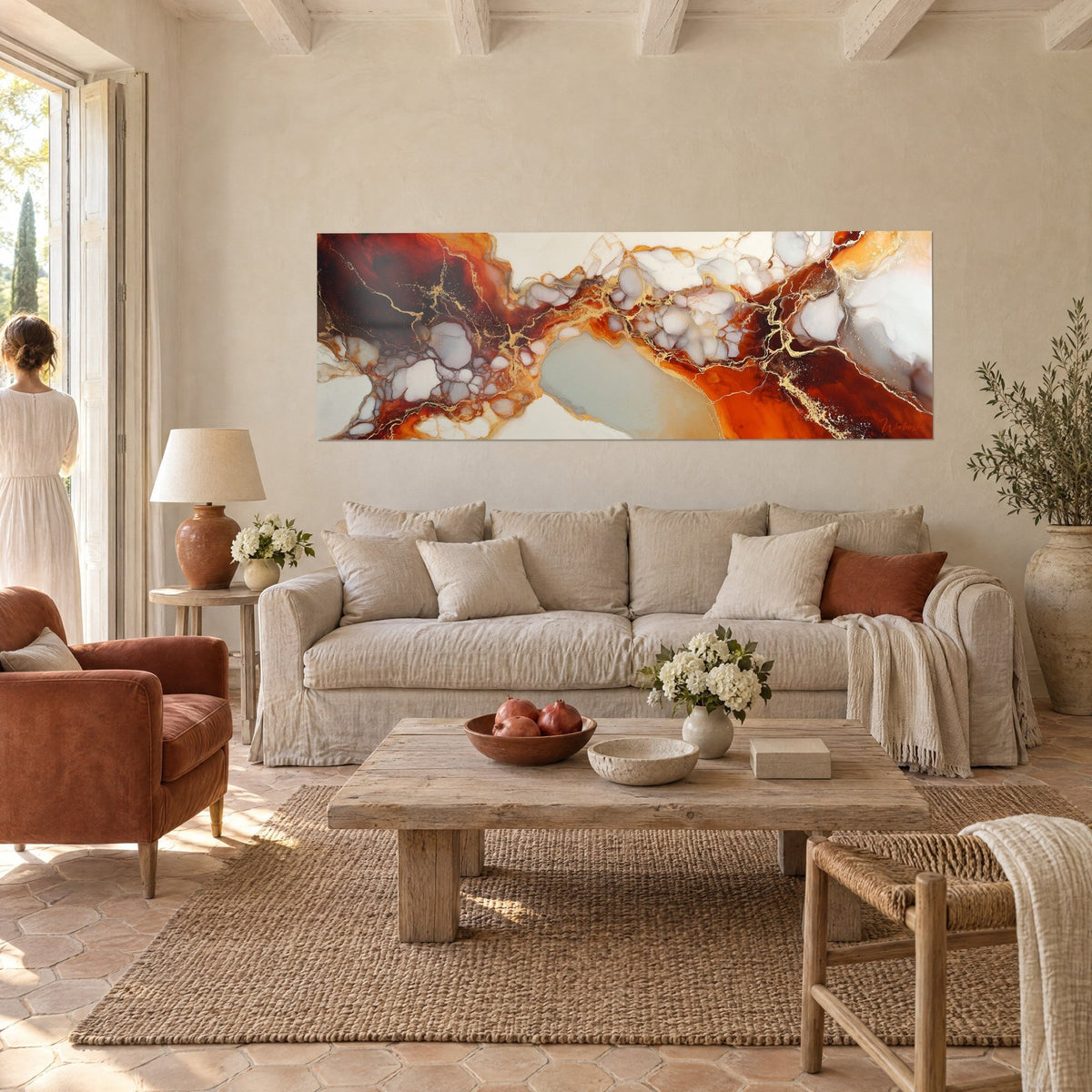 Wall art of fluid marble with golden veins on ivory and rust background, couple seen from behind, above a sofa in a bright living room