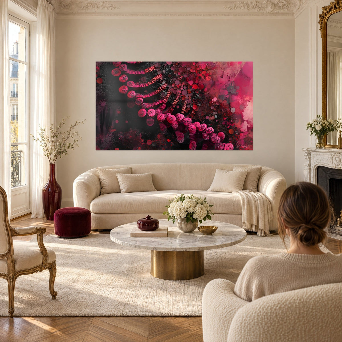 Wall art double DNA helix of fuchsia beads on black background, red accents, couple seen from behind, above a sofa in a bright living room