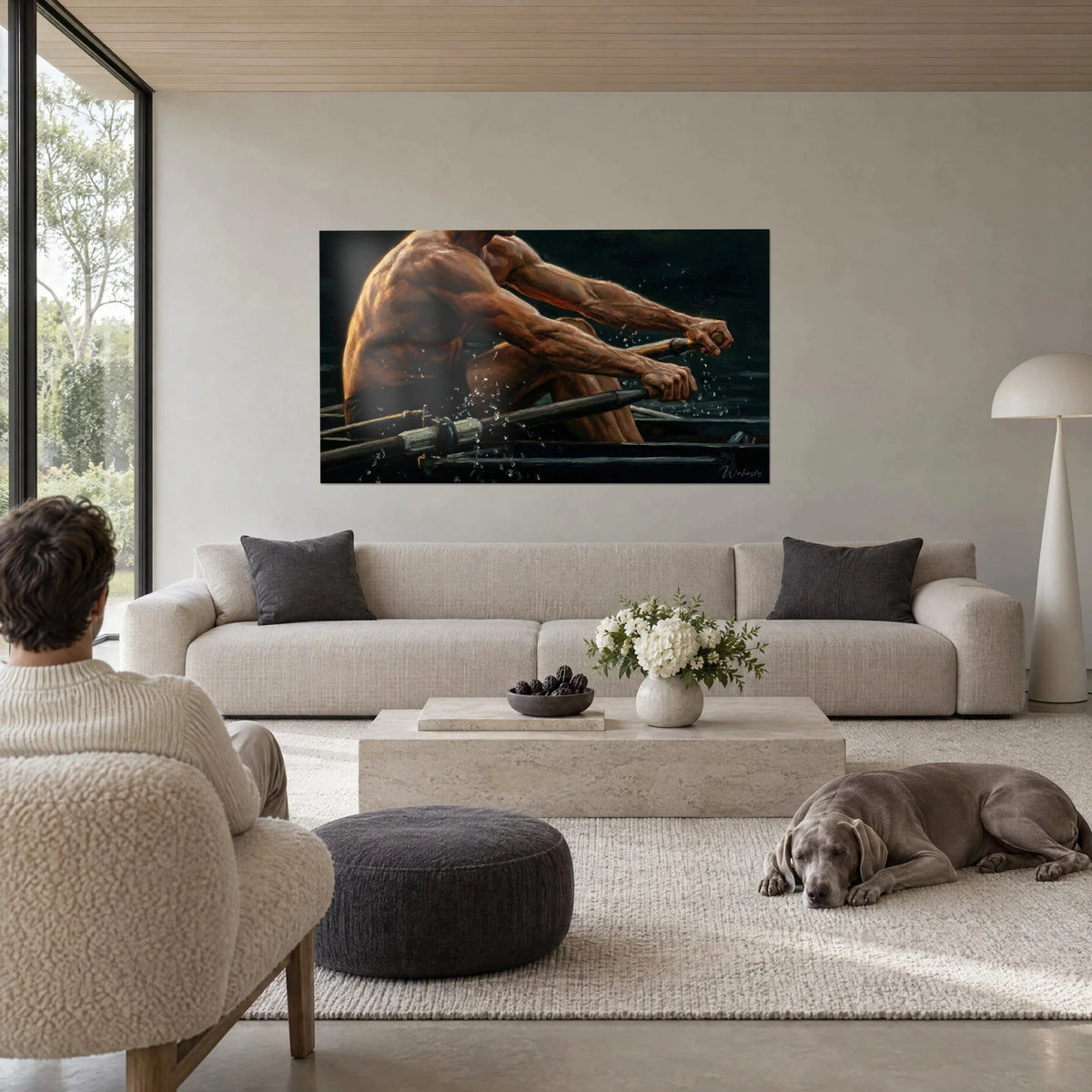 Wall art of a rower with a muscular torso, copper skin and black background, water splashes, above a sofa in a bright living room