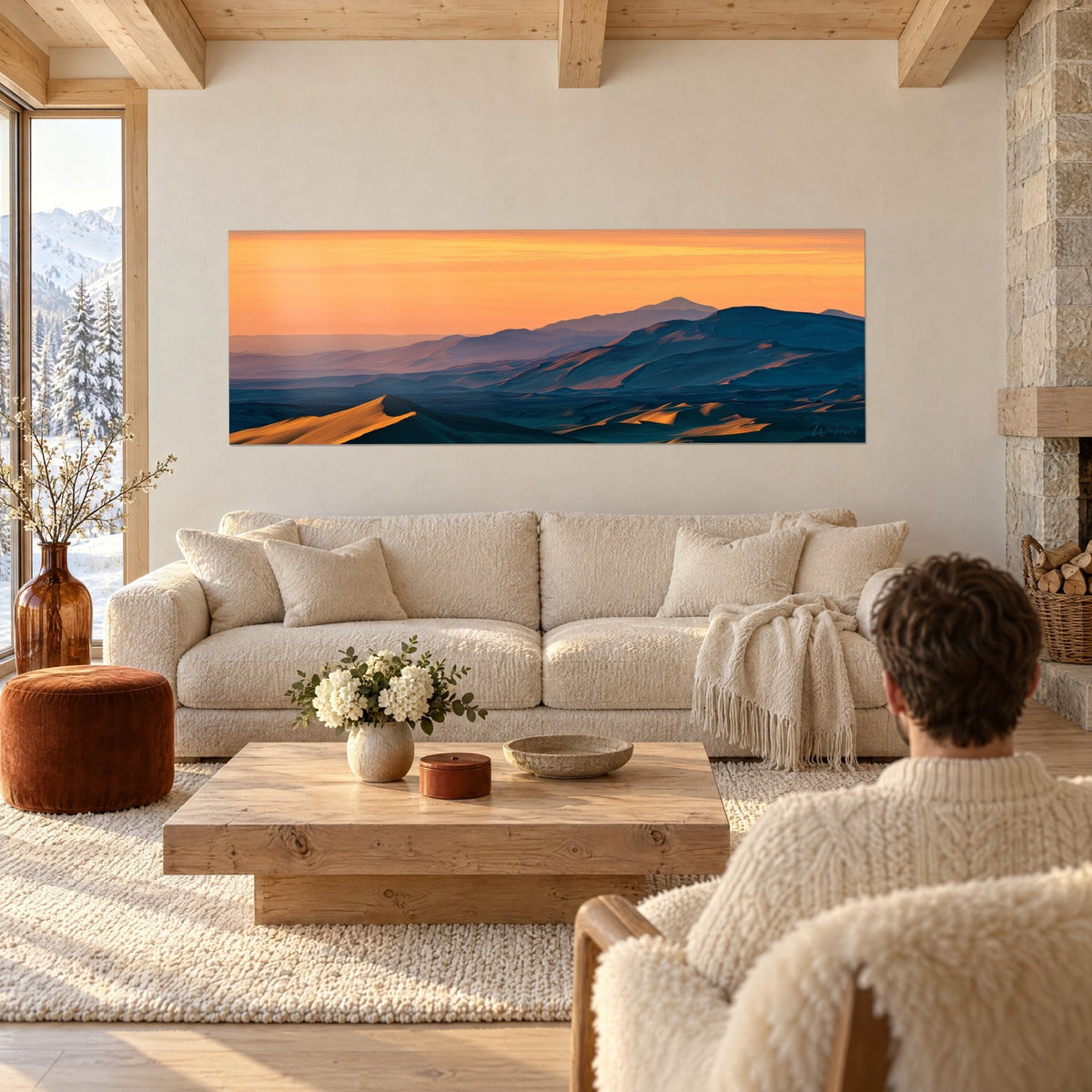 Wall art desert ridges under an amber sky, golden dunes and midnight-blue hills, above a sofa in a bright living room