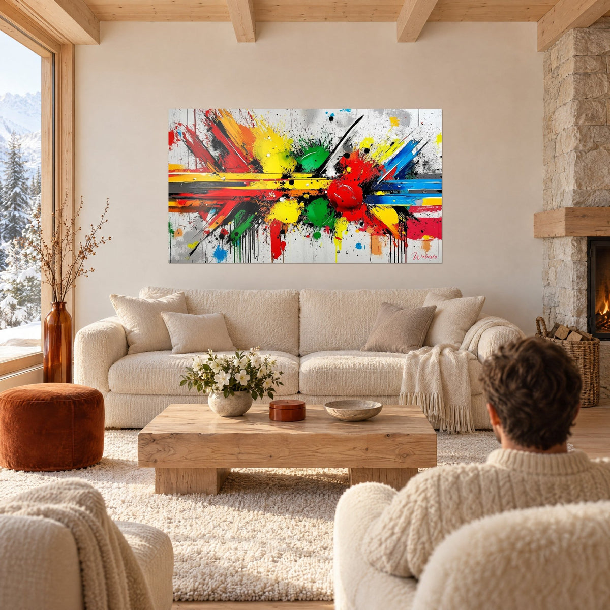 Wall art explosion of yellow and red paint, green and black splashes, man seen from behind, above a sofa in a bright living room