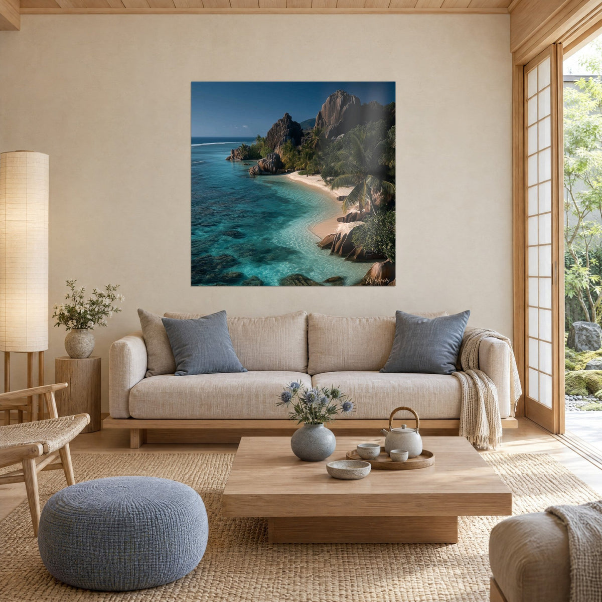 Wall art turquoise lagoon framed by dark granite and green palm fronds, blond sand, above a sofa in a bright living room