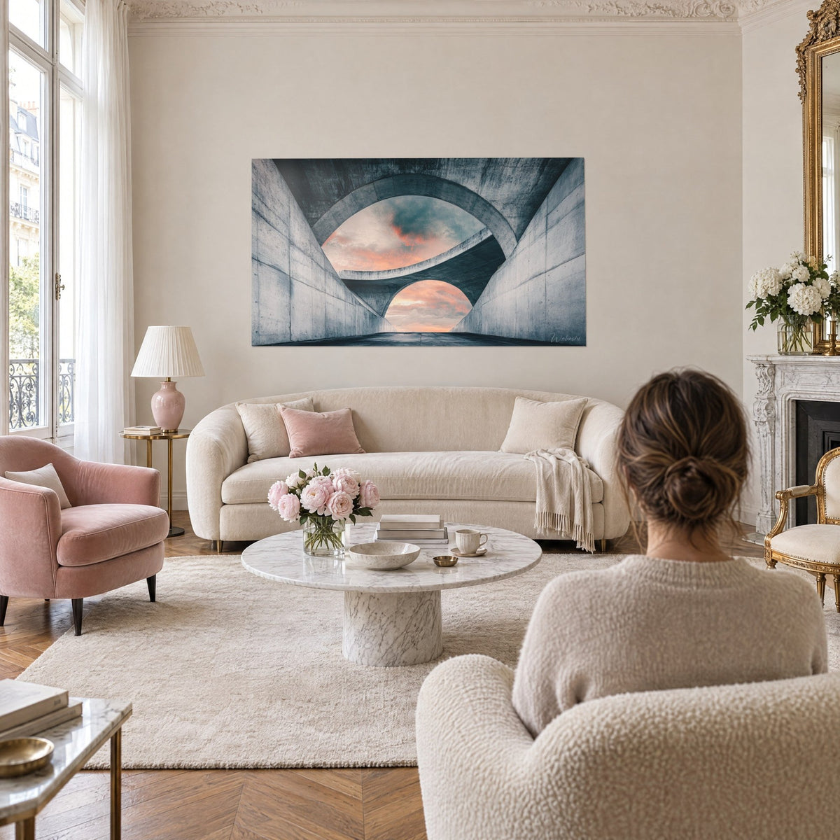 Wall art raw concrete tunnel with interlocking arches, orange and steel-blue sky, above a sofa in a bright living room