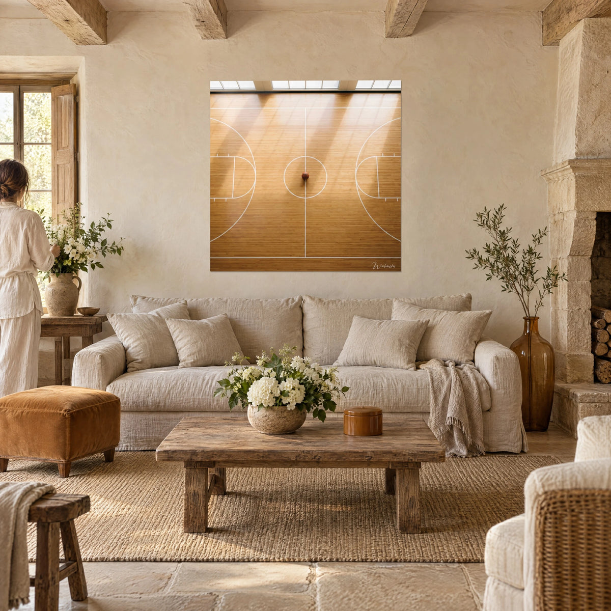 Wall art aerial view of a basketball court, honey parquet and white lines, two people seen from behind, above a sofa in a bright living room