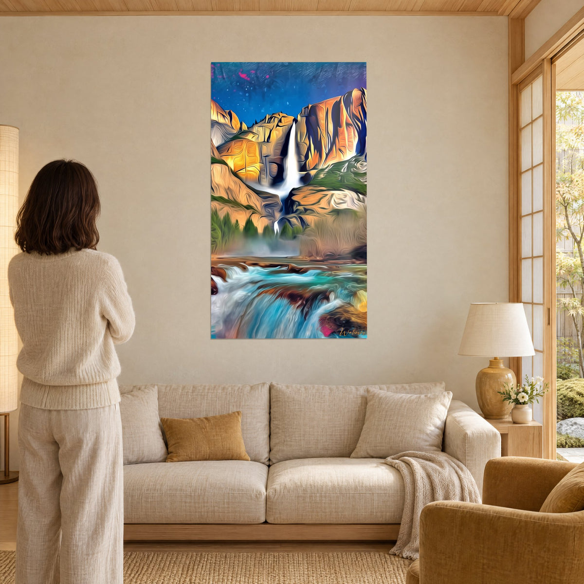 Wall art majestic waterfall with ochre and golden cliffs, turquoise torrent in the foreground, woman seen from behind, above a sofa in a bright living room