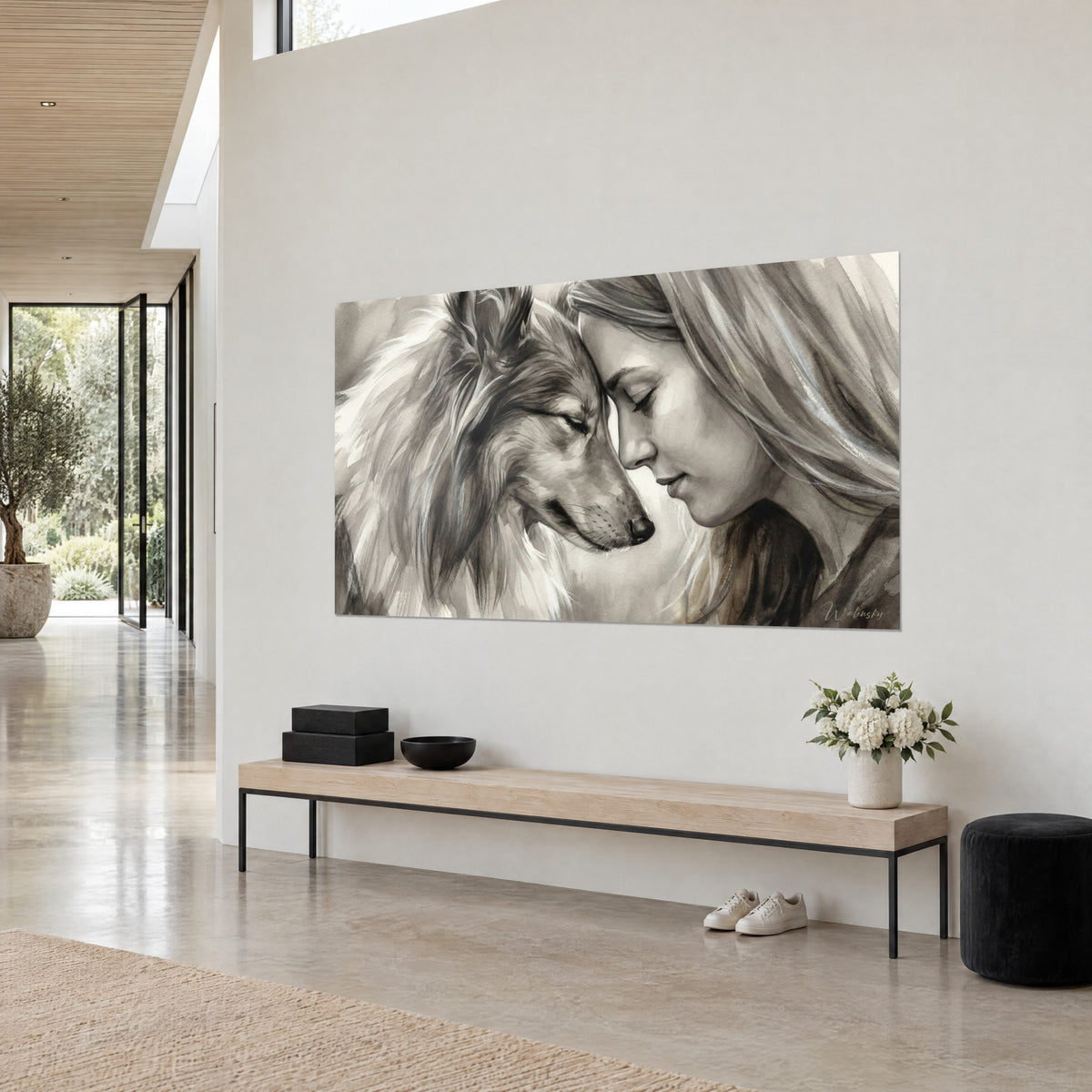 Cuadro pastor de Shetland de pelaje crema y marrón, hocico bajo junto a una mujer rubia, vista de un banco beige
