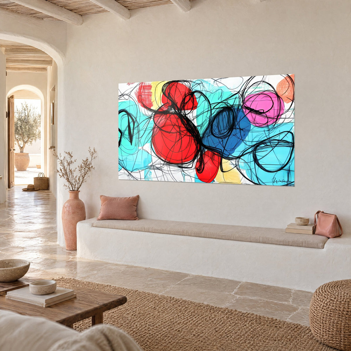 Wall art bursting with color, large scarlet and royal blue circles scribbled over in black, above a white stone-toned bench