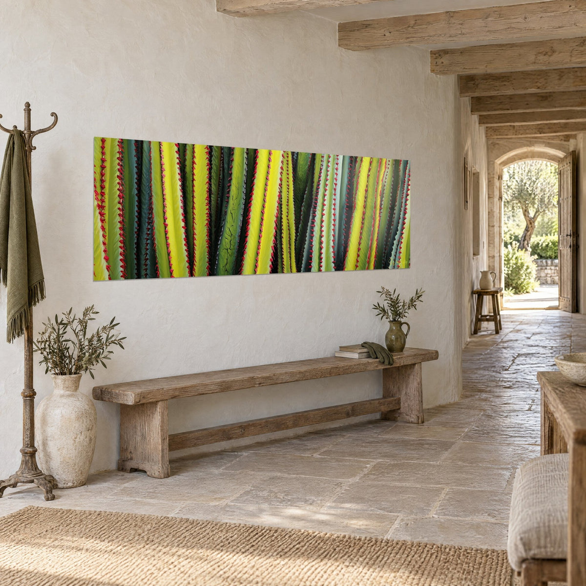 Wall art plant columns in lemon yellow and fir green speckled with red, seen at an angle in a corridor of pale stone