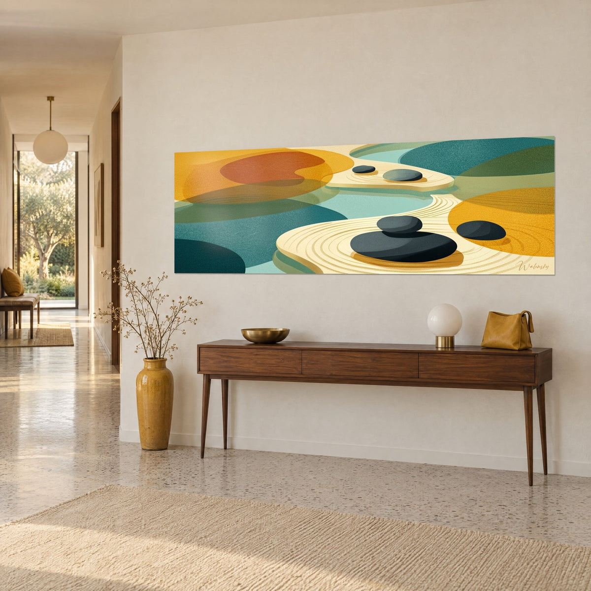 Wall art anthracite pebbles resting on cream striated sand, burnt orange and turquoise color blocks, beige wall and wooden console, bright entryway