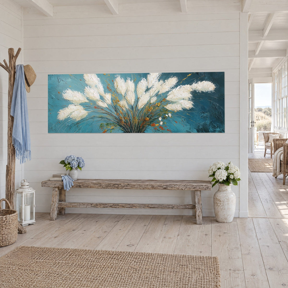 Wall art cream pampas grass plume on deep turquoise, golden stems fanned out, on a white wall, rustic wooden bench