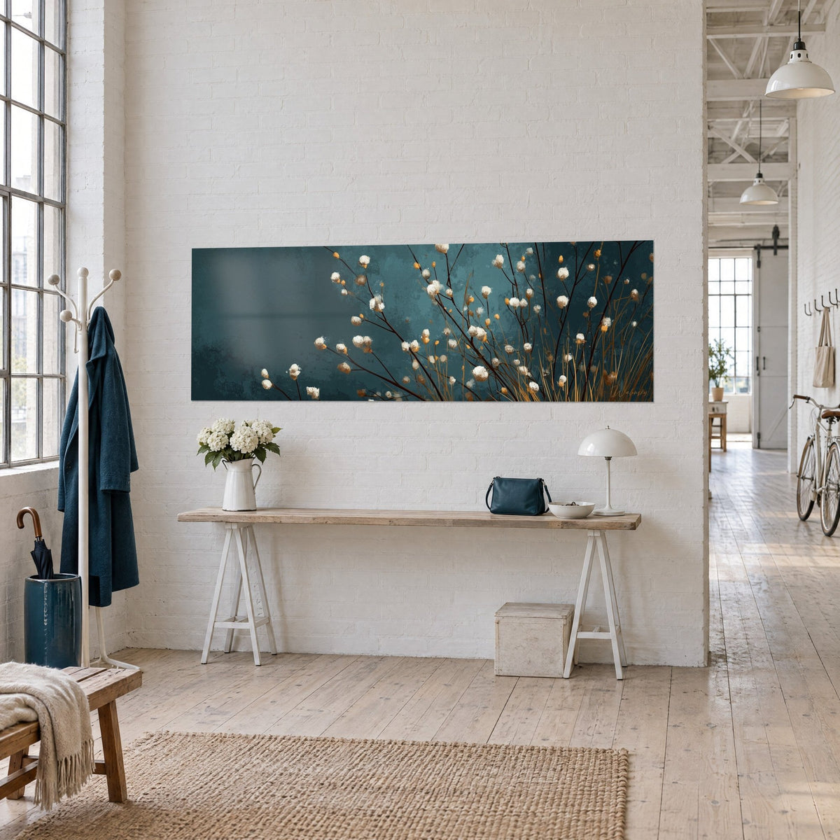 Wall art with brown branches dotted with ivory and ochre buds on a deep turquoise background, wooden console, bright loft