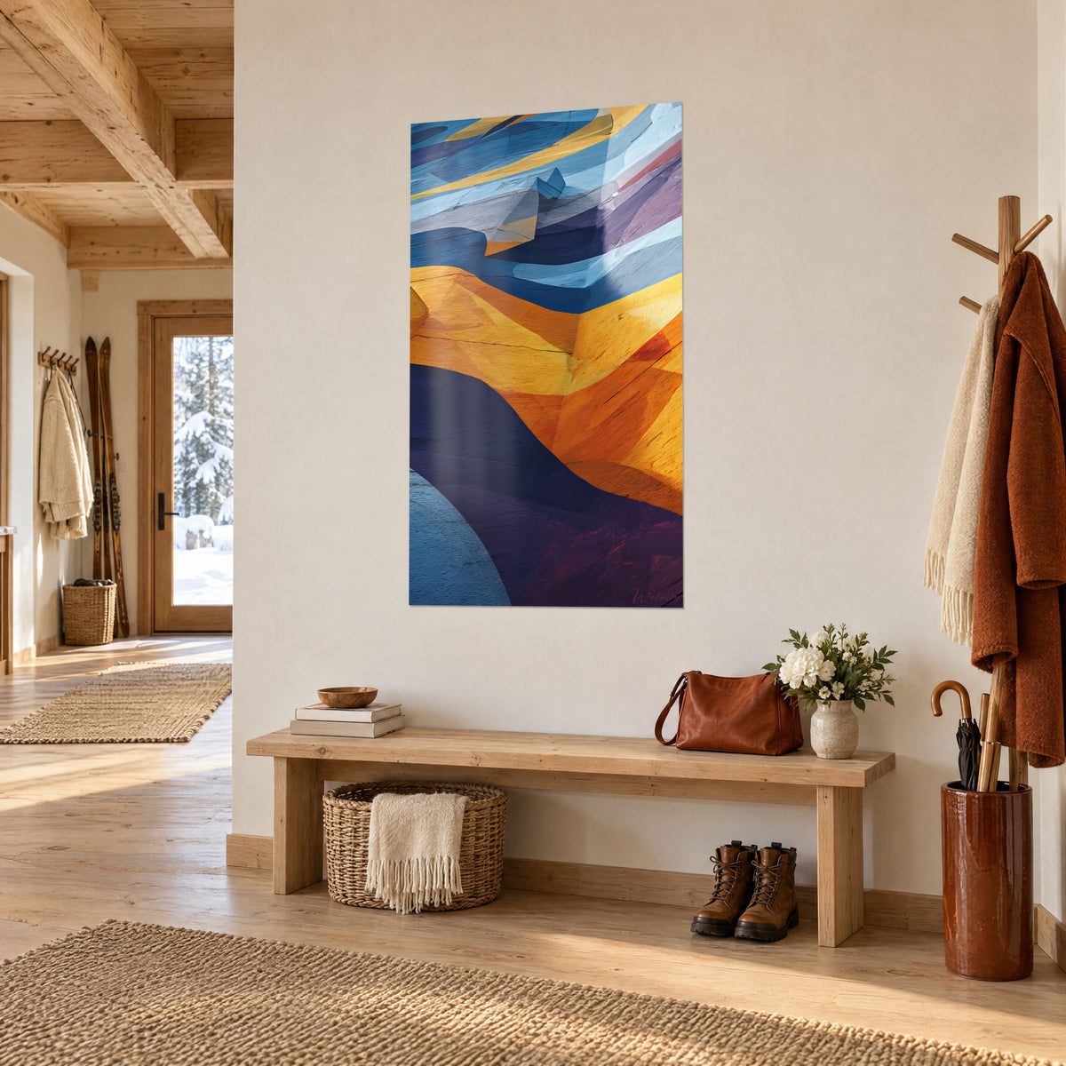 Tableau falaise stylisée aux plans géométriques orange et bleu ciel, vue de trois quarts dans l'entrée d'un chalet