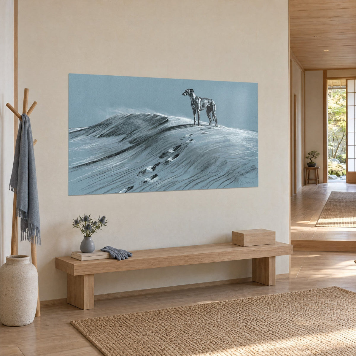 Wall art of a greyhound in profile atop a snowy ridge, black and white paw prints, in a japandi hallway, three-quarter view