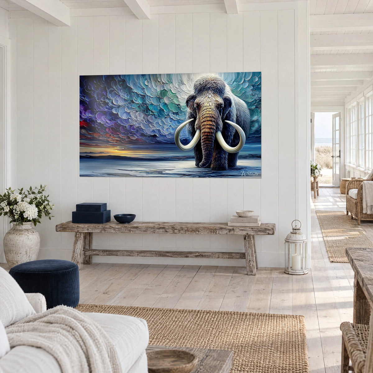 Cuadro paquidermo prehistórico con trompa cobriza, cielo violeta y azul escamado, sobre una pared blanca de casa junto al mar