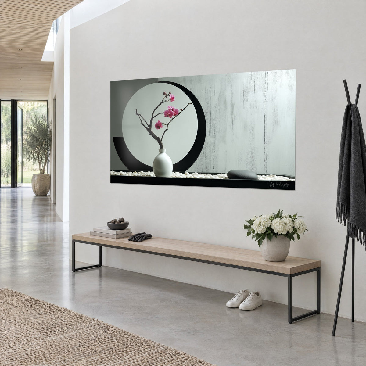 Wall art minimalist ikebana, magenta flowers on dark branch, white pebbles and black circle, three-quarter view of a wooden bench