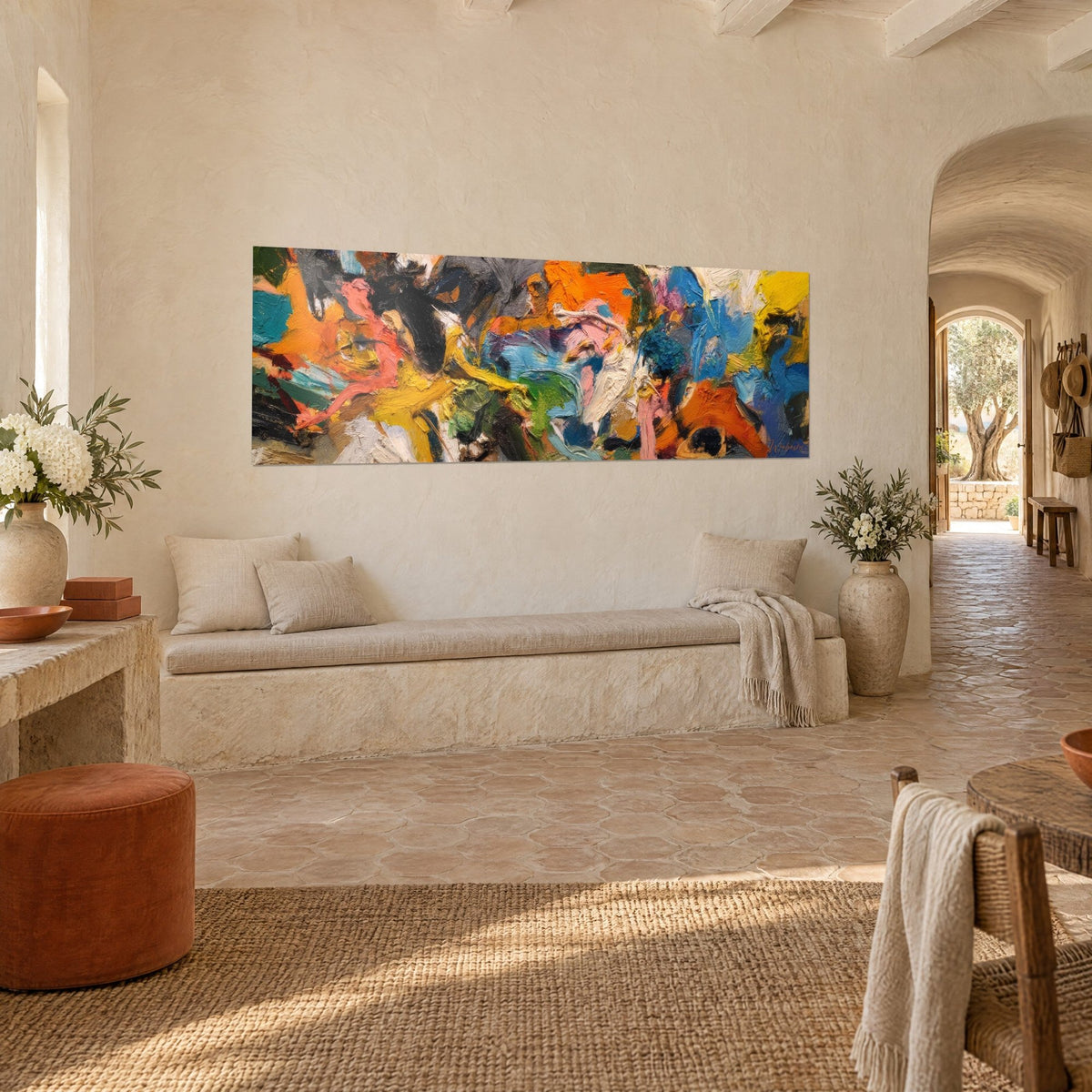 Wall art chaos of thick orange and turquoise, pink and black brushstrokes, seen from three-quarter view in a Provençal farmhouse