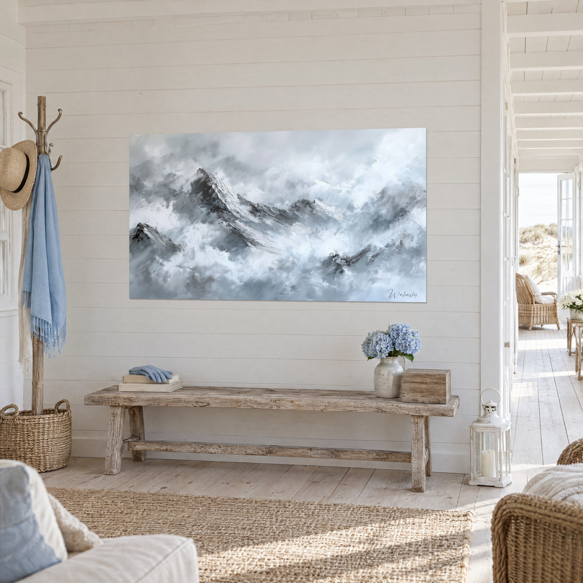 Wall art alpine massif under the clouds, white ridges and black shadows, panelled wall and wooden bench, seaside house