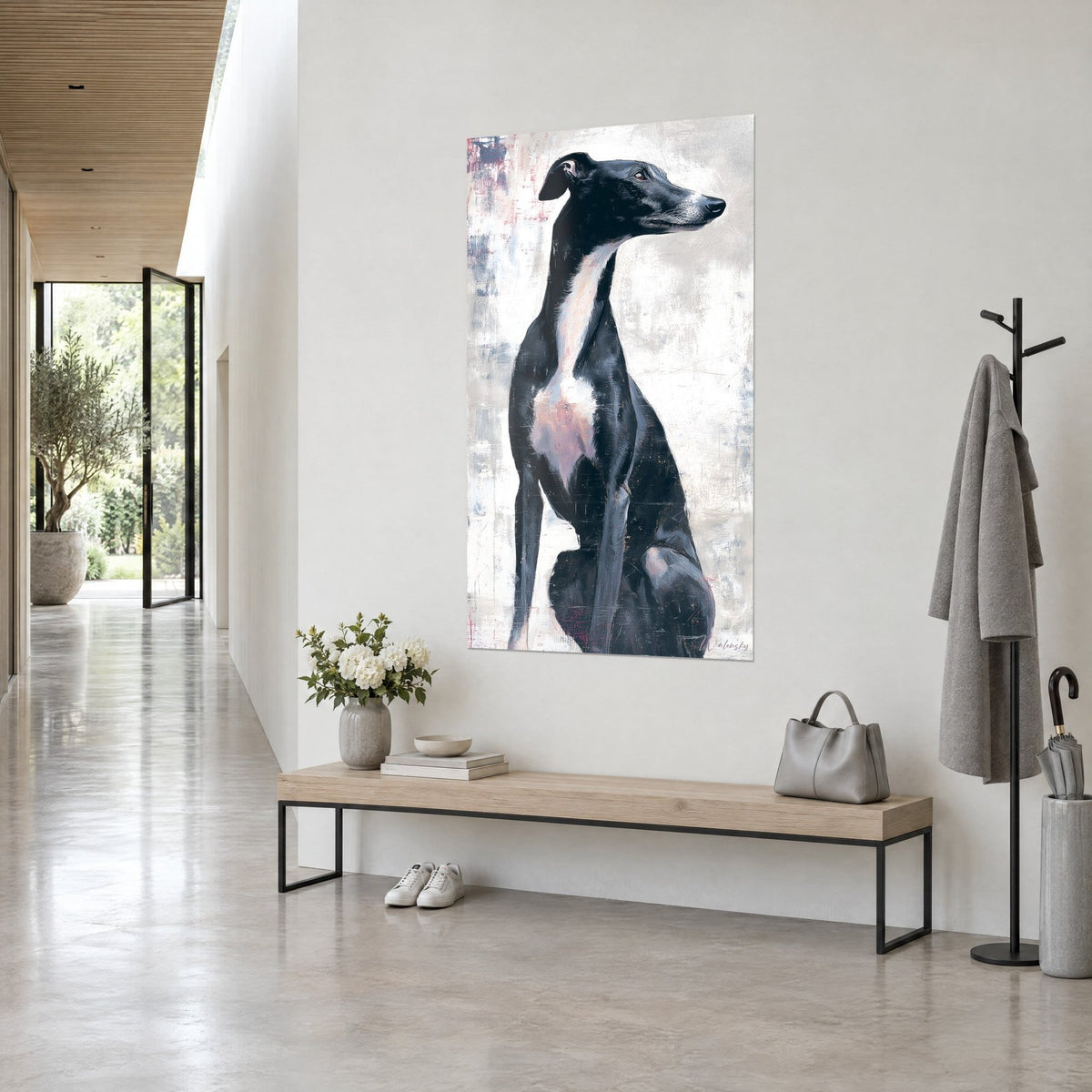 Wall art whippet in profile, ink-black coat and white chest, muzzle turned right, at the end of a hallway and a wooden bench