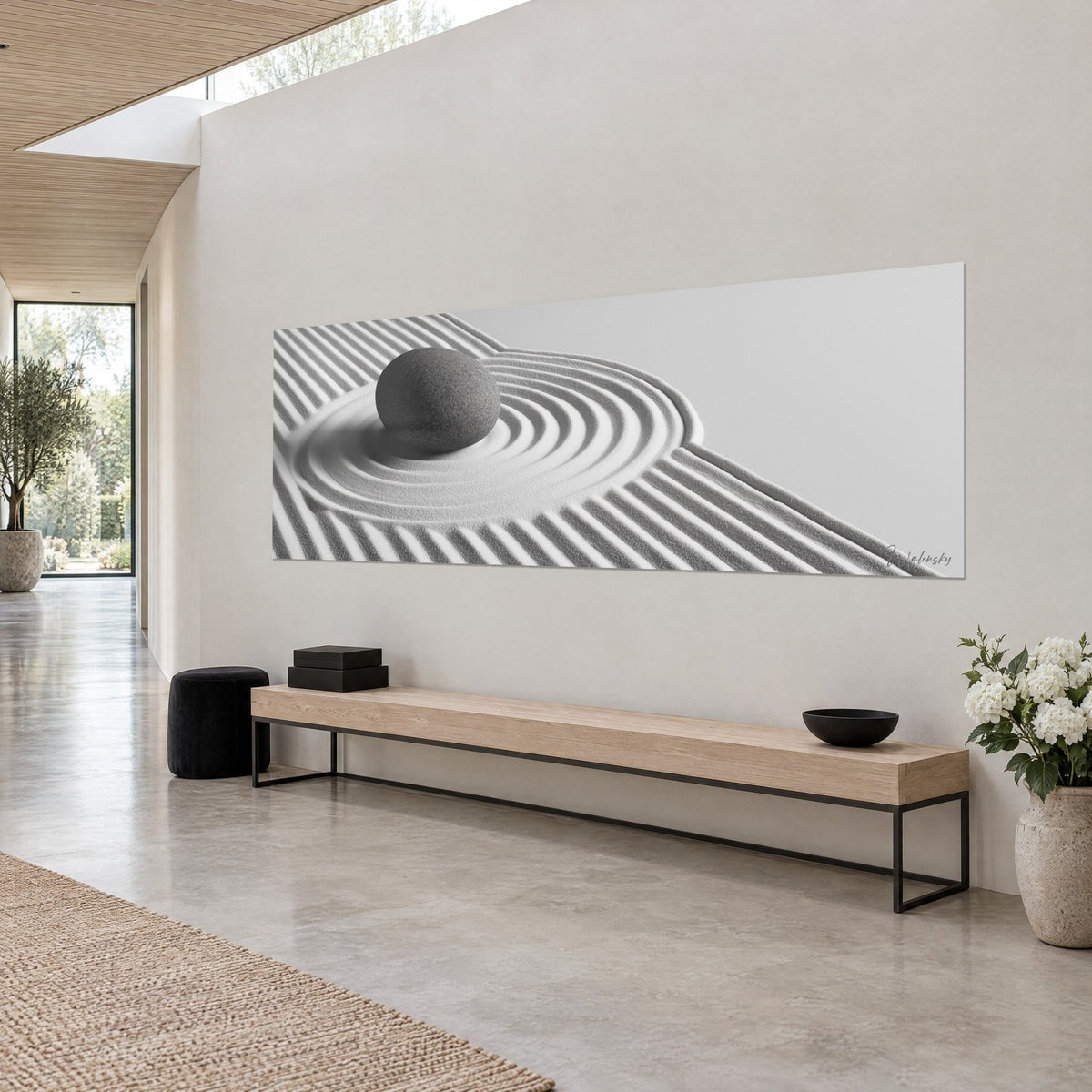 Wall art oval anthracite stone at the centre of light sand ripples, grey and white stripes, on a three-quarter view wall