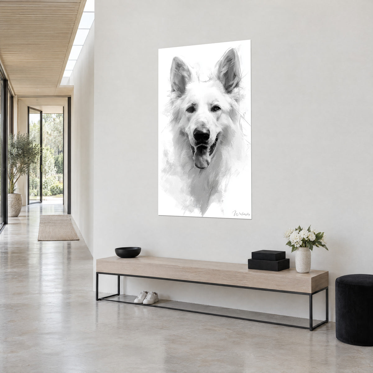Cuadro perro blanco de mirada dulce, hocico negro y fondo impecable, sobre una pared gris junto a un banco de madera clara y un pasillo acristalado