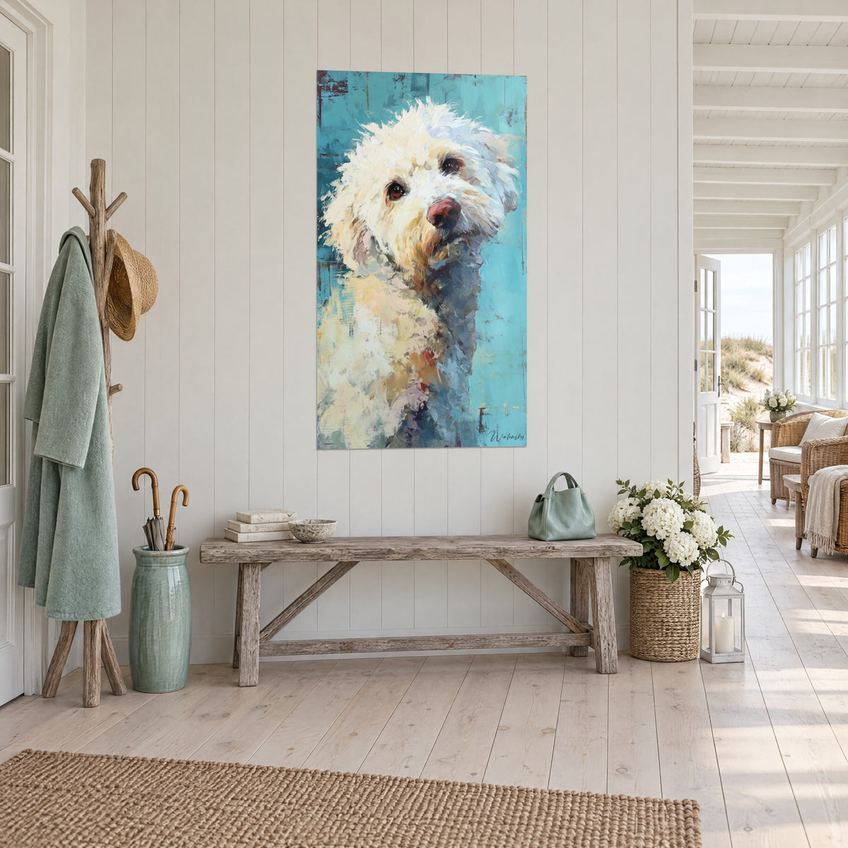 Cuadro perro rizado de hocico rosa, pelaje marfil y fondo azul, en la pared de una entrada luminosa junto al mar