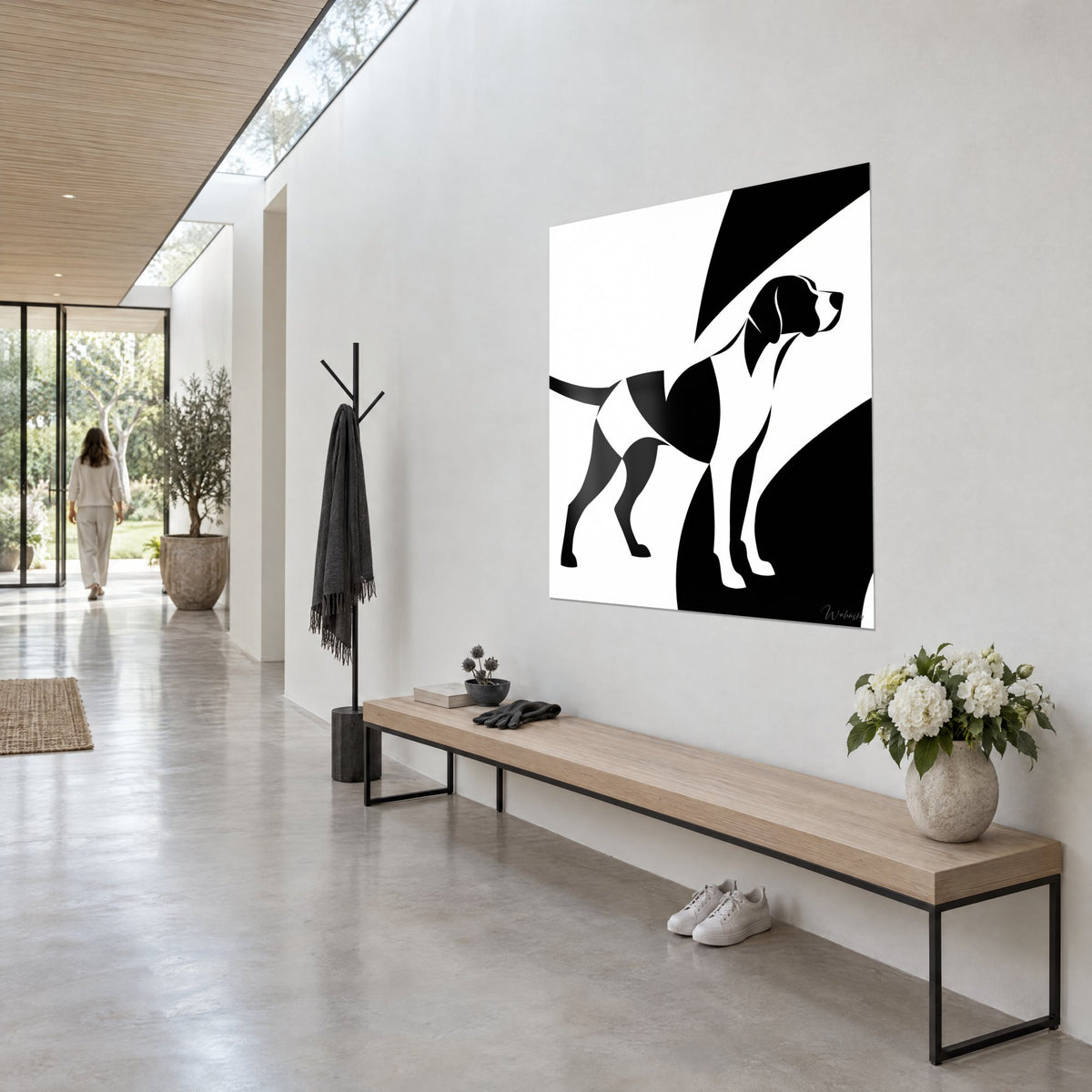 Wall art of a pointer on point, muzzle raised, large black and ivory curves behind it, seen three-quarter view in a light concrete hallway
