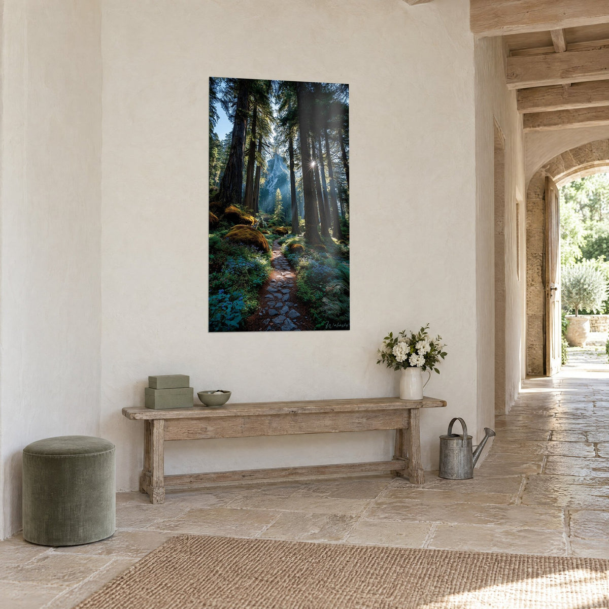 Wall art giants' trail beneath tall brown trunks and a bluish rock in the mist, three-quarter view in a stone hallway