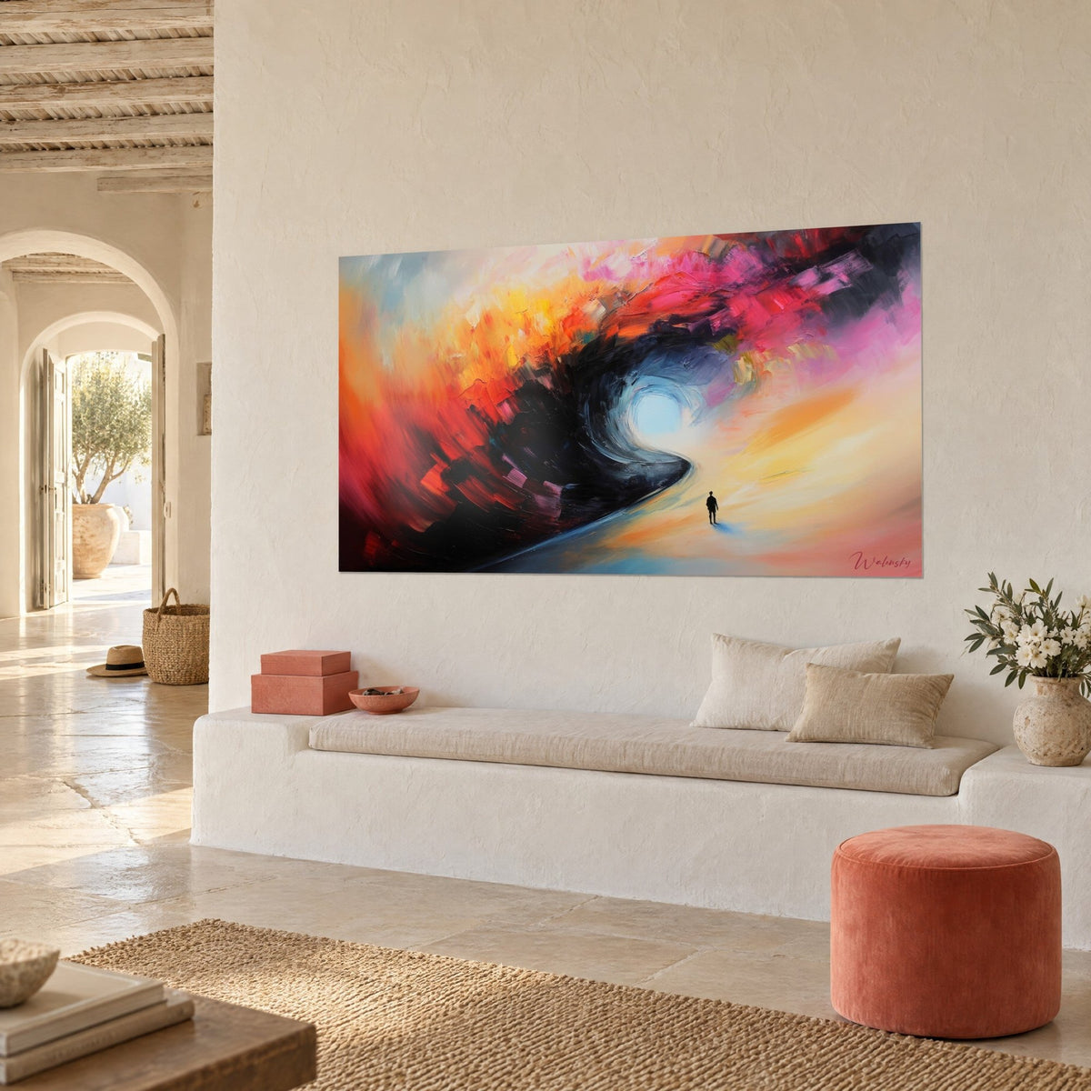 Wall art black and glacier blue vortex ringed with bright red, small walker at the end of a road, white wall of a Mediterranean house