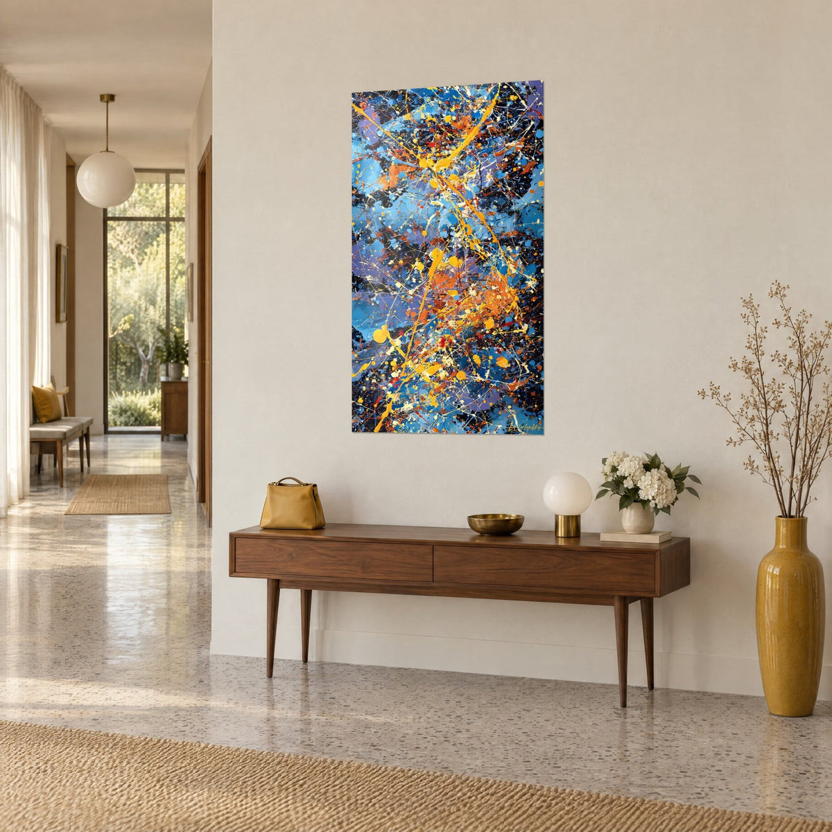 Wall art abstract dripping canvas, golden yellow splashes and blue streaks, three-quarter view, on a beige hallway wall